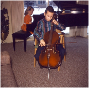 Gary performing on his Kay cello, with younger sister Barbara accompanying