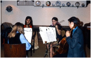 A string quartet from high school (L-R): Barbara Stucka (viola), Robin Fossum and Elizabeth Prielozny Barnes (violins), Gary Stucka (cello)